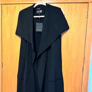 New Tessana by Mackage is a full-length sleeveless vest with water fall collar